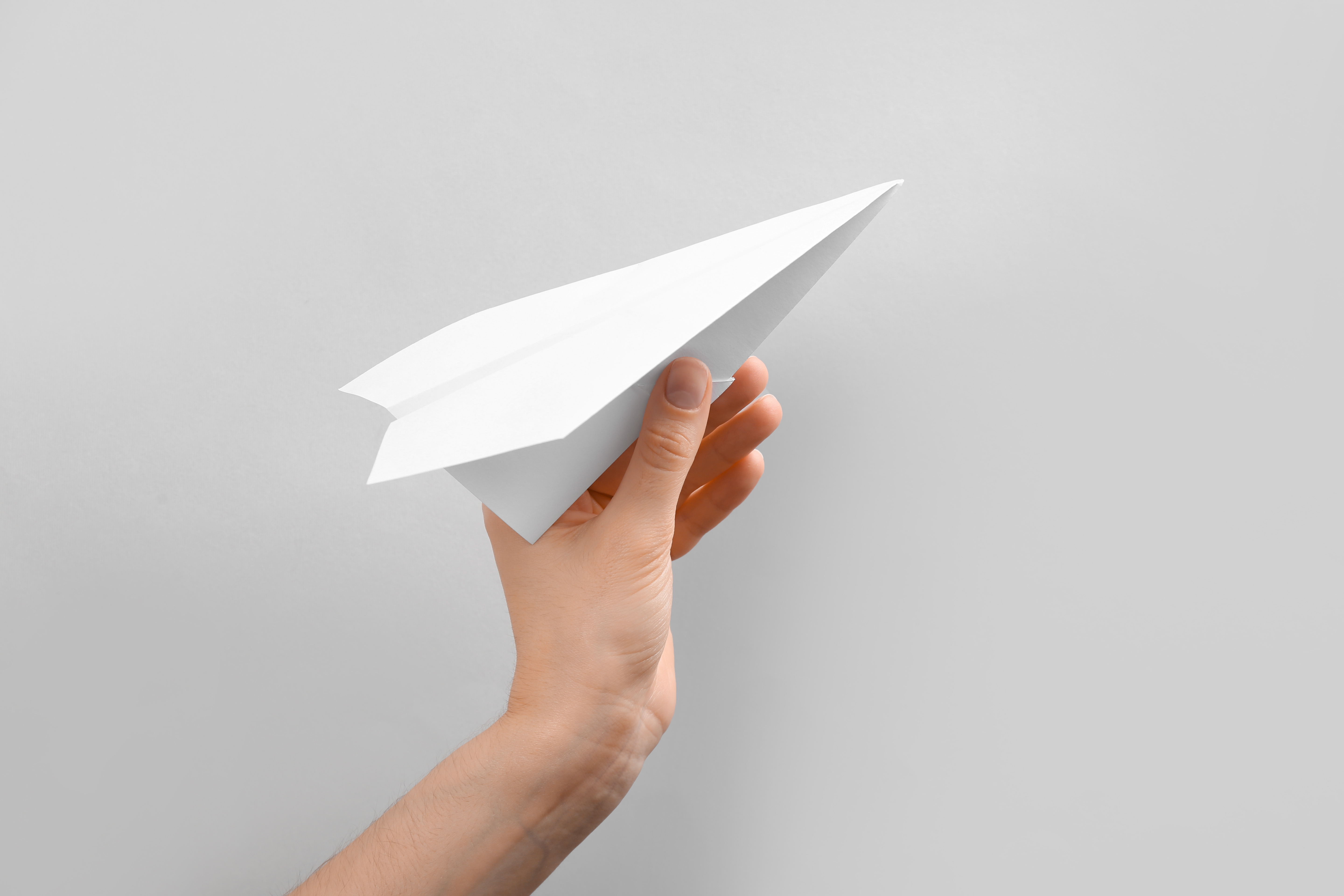 hand holding a paper airplane